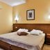 Hotel Stella di Mare in Bečići offers a double bed room with wood headboard and wall sconces