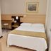 Hotel Steinhausen Blumenau guest room with twin bed, desk, chair and wall mirror