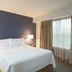 Residence Inn by Marriott New Bedford Dartmouth bedroom with king bed, bedside lamps, and window curtains