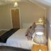 The Kings Head, Meifod: cozy guest room with double bed, desk, wall-mounted TV and bedside lamps