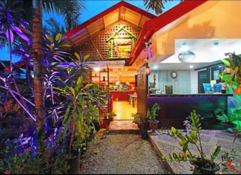 Adriana's Place Tropical Guesthouse in Panglao with a tropical-lit entrance and lush garden path