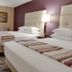 Drury Inn & Suites San Antonio Northeast room with two queen beds and bedside lamps in San Antonio