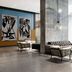 The Elser Hotel Miami lobby lounge in Miami with floor-to-ceiling windows, tufted sofa, and abstract art.
