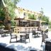 Nur Apart in Marmaris: outdoor poolside cafe seating with tables, chairs, and hotel buildings