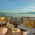 Gaya Island Resort, Kota Kinabalu: ocean-view terrace with cushioned seating and sunset over calm water