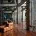 Stamba Hotel in Tbilisi lobby with tall bookshelves, leather seating and industrial concrete columns