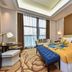Pearl River Garden Hotel Changsha room with large window, city view, and colorful bedspread