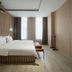 Haobo International Hotel in Wuxi guest room with king bed, tall windows, and wood-paneled walls