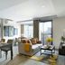 Somerset Rama 9 Bangkok suite with dining area, sofa, city-view windows, and balcony in Bangkok