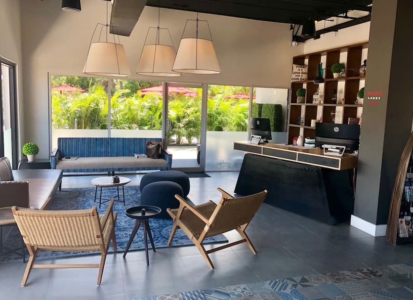 The Locale Hotel Grand Cayman lobby with lounge seating and reception desk in West Bay