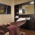Hotel Fire & Ice Düsseldorf/Neuss spa treatment room in Neuss with massage table and mountain wall art