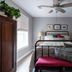 Glenn Meadow Bed and Breakfast in South Haven room with a bed, ceiling fan, and framed wall art