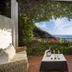Hotel Pellegrino in Praiano with terrace seating, flowering vines, and sea view