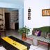 Eco Suites Uxlabil Guatemala living room with sofa, dining table, brick alcove and potted plant in Guatemala City