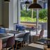 Mercure Hotel München Schwabing restaurant seating with large windows and outdoor terrace views in Munich
