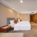 Wanhao International Hotel in Benxi guest room with twin beds, wall-mounted TV and carpeted floor