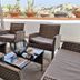 Villa Ambra B&B in Noto: wicker seating on a rooftop terrace with city views and potted plants