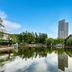 New Century Hotel Pudong Shanghai in Shanghai with a lake reflecting the tower and trees