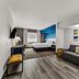 Comfort Inn & Suites Donna guest room with king bed, sofa, desk, and city view