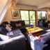 Haka Lodge Christchurch lounge with sofas, coffee table, TV, and sliding doors to a balcony
