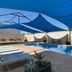 The Phoenix Artesian Spa Resort and Accommodation, Moree rooftop pool with blue shade sails and loungers
