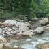 Las Brisas Resort and Villas in Jacó featuring a rocky jungle stream with flowing water