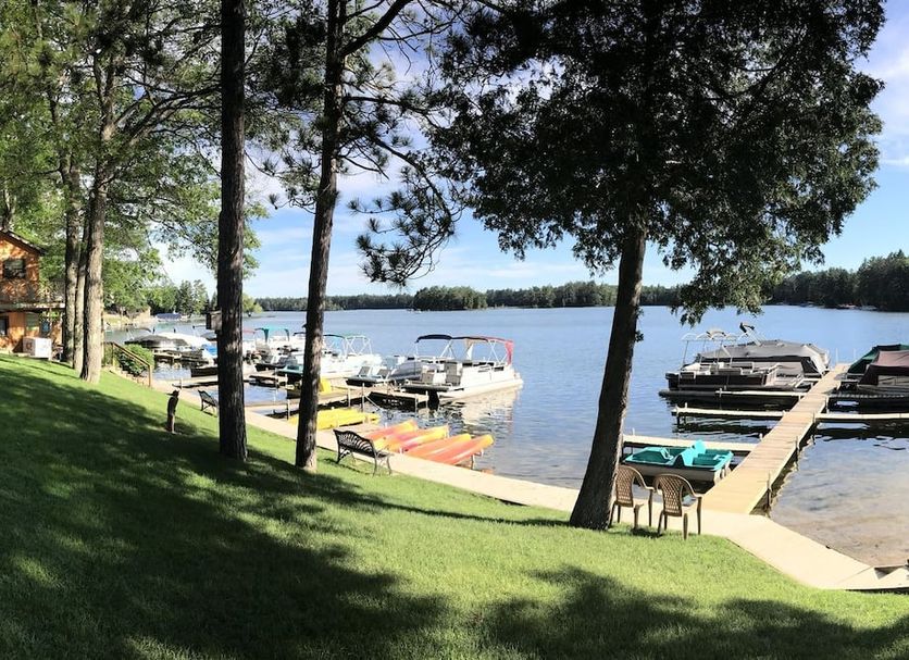 Clear Lake Resort in West Branch with lakeside docks, boats, and a grassy waterfront lawn