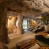 Hotel Cala del Pi - Adults Only in Platja d'Aro: cave-style spa with lounge chairs and palm plants