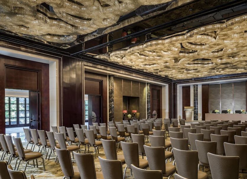 Four Seasons Hotel Hangzhou at West Lake meeting room with rows of chairs and ornate ceiling