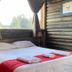 Hosteria Posta de los Colonos room with king bed, wood walls and forest view in Villa La Angostura