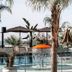 Le Palazzine Hotel in Vlorë with outdoor pool, waterfall feature, palm trees and sun umbrellas
