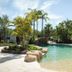 Koala Shores Port Stephens Holiday Park in Taylors Beach with tropical lagoon-style pool and palm trees