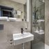 Michel Hotel Waldkirchen am Badepark bathroom with walk-in shower and wall-mounted sink in Waldkirchen