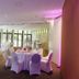 Hardtwald, Bad Homburg: banquet room with round tables, white chair covers and purple accent lighting