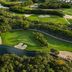 Aerial view of Jungala Hotel at VidantaWorld Riviera Maya in Cancún with golf greens, water, and trees.