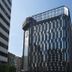 Hotel Midtown Richardson in Taipei City, tall modern glass hotel tower against blue sky