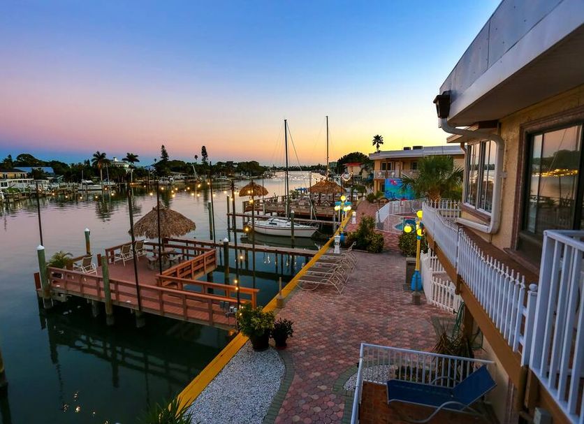 Bayview Plaza Waterfront Resort in Saint Pete Beach with marina dock and waterfront sunset view