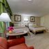 Skaket Beach Motel in Orleans room with two beds, seating area, and kitchenette nook