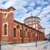 B&B I 10 Mondi in Milan, red brick church beside a domed building on a city square
