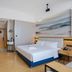 Kyriad Hotel Guangzhou Panyu Aoyuan Plaza guest room with double bed and mountain wall art in Guangzhou