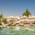 Nobu Hotel Marbella in Marbella: rooftop pool with loungers and umbrellas beside tropical landscaping