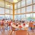 Séjours & Affaires Paris-Vitry dining room with large windows and city views in Vitry-sur-Seine