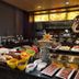 Holiday Inn & Suites Hulunbuir buffet breakfast display with assorted dishes and fruit