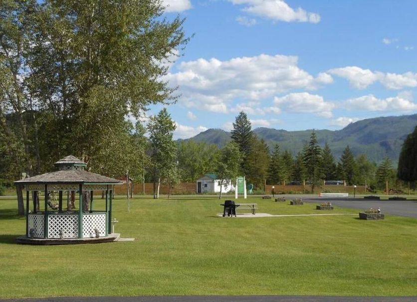 Mountain Springs Motel & RV Park in Barriere, grassy grounds with gazebo and mountain views