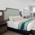 The Capitana Key West guest room with king bed, seating area, and balcony view of the water in Key West.