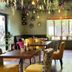 The Churchill Court in Woodstock dining room with floral ceiling decor, mixed chairs, and window seating