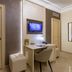 Vittorio Emanuele Boutique Hotel in Sciacca: guest room with desk, wall TV, and open bathroom doorway