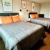 The 409 Bolivar Beach Hotel in Bolivar Peninsula guest room with two beds and wall art