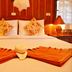 Sayang Beach Resort in Ko Lanta bedroom with a neatly made bed, floral pillows, and warm wood paneling