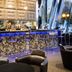 Eurostars Palace Córdoba hotel bar with backlit counter, tall stools, and lounge seating